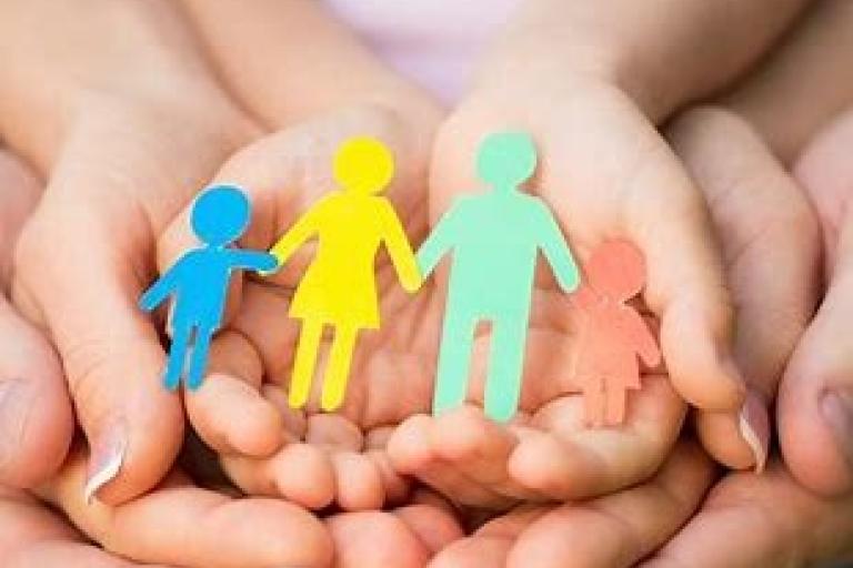 cupped hands with paper cut out of family members