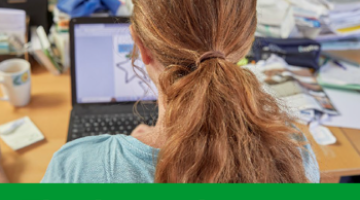 young female sitting in front of laptop