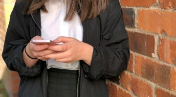 young girl holding mobile phone