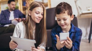 girl and boy on devices