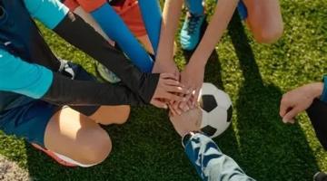 young children hands on top of each sports field